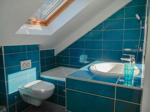 a blue bathroom with a toilet and a sink at Maison Sauzon, 5 pièces, 8 personnes - FR-1-418-201 in Sauzon