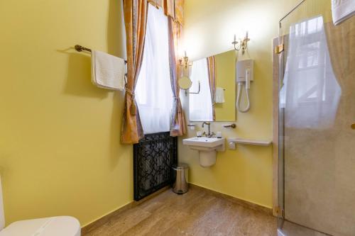 a bathroom with a toilet and a sink and a shower at Hotel Am Ring in Sibiu