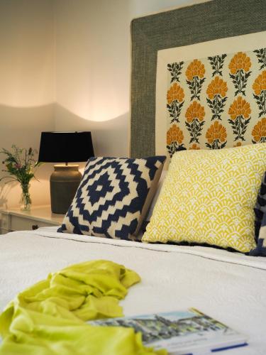 a bedroom with a bed with a yellow shirt on it at St Michael Liston Suite in Corfu