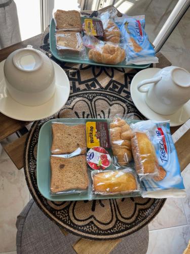 two plates of bread and pastries on a table at Bellevue Herculaneum B&B in Ercolano