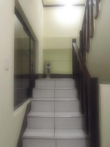 a stairway with white steps and a mirror at Hostal Pablo's House in Machu Picchu