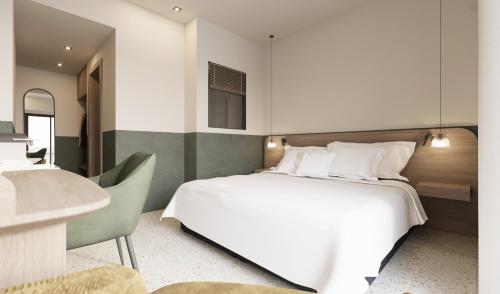 1 dormitorio con 1 cama blanca grande y escritorio en Evripidou 7 - Kalamata Mediterranean Suites, en Kalamata