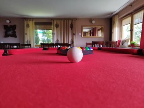 a large red carpeted room with a ball on the floor at Tatrzańska Panorama in Gliczarów