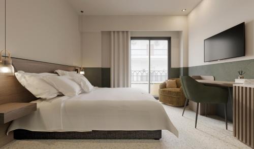 a bedroom with a large white bed and a desk at Evripidou 7 - Kalamata Mediterranean Suites in Kalamata