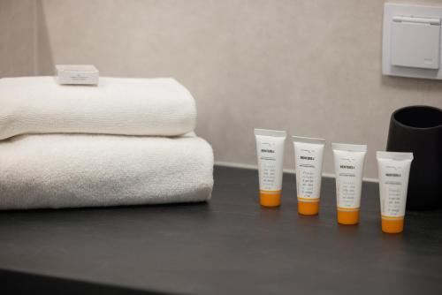 a group of four cups sitting on a table next to towels at Wellness Resort & SPA Dziwnów Apartments with Parking by Noclegi Renters in Dziwnów