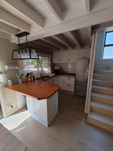 a kitchen with a wooden counter top in a room at Aurora's Rest 47 in Fisherhaven