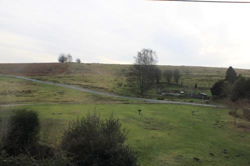 a grassy field with a road in the distance at Halmer Grange Guest House in Goathland