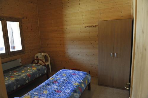 a small room with two beds and a cabinet at Holiday Home Bagnara in Nocera Umbra