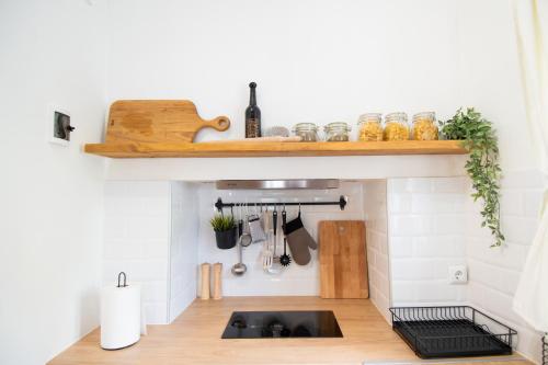 a kitchen with a sink and a shelf above it at Cozy House Old Town in Xanthi - Meno Homes 1 in Xanthi