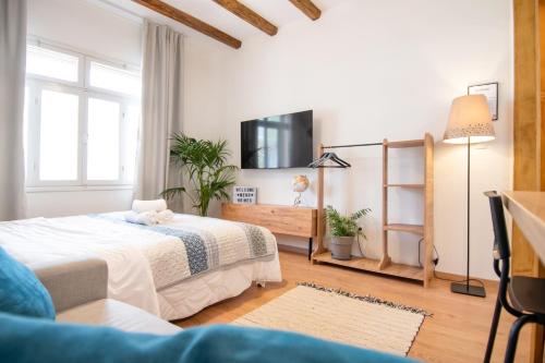 a bedroom with two beds and a flat screen tv at Cozy House Old Town Xanthi - MenoHomes 1 in Xanthi