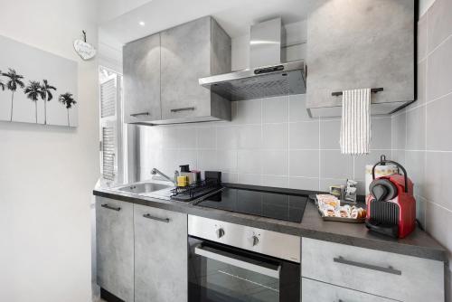 a kitchen with stainless steel cabinets and a sink at Edda's apartment in Altare