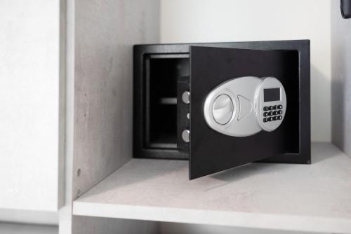 a safe with a door open on a shelf at Edda's apartment in Altare
