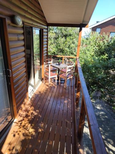 a deck with a table and chairs on it at Aurora's Rest 47 in Fisherhaven