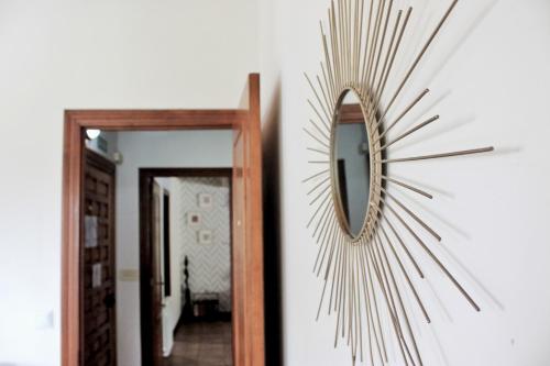 a mirror on a wall next to a hallway at La Casa del Piano - 5831 in Isla
