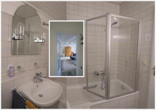 a bathroom with a sink and a shower with a mirror at Ferienwohnung Abendrot in Bodenmais