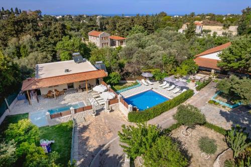 an aerial view of a house with a swimming pool at Villa Rafaela in Koskinou