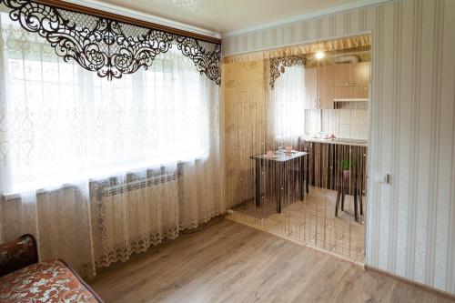 a room with a window and a kitchen with a table at Luxury apartment Gagarina street in Kryvyi Rih