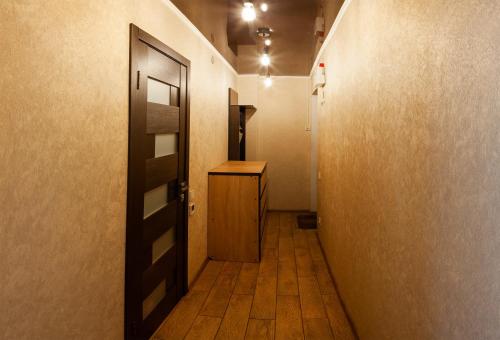 a hallway with a door and a wooden floor at Luxury apartment Gagarina street in Kryvyi Rih