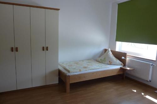 a small bedroom with a bed and a window at Ferienwohnung Willner in Kastl