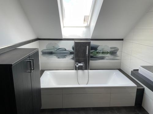 a bathroom with a bath tub with a window at Narnhoferwirt in Sankt Jakob im Walde