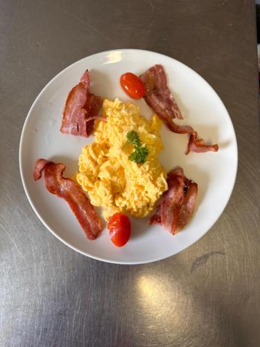 a plate of breakfast food with bacon and eggs at Shandon Bells Guest House in Cork