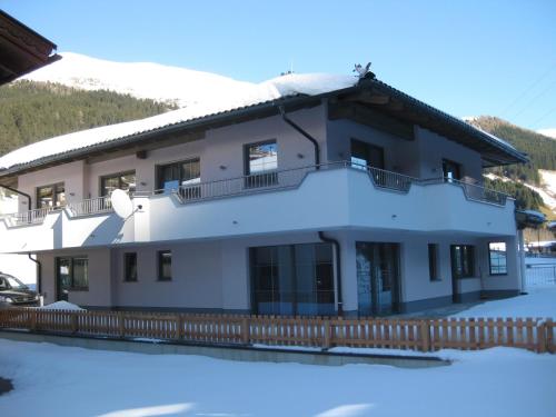 a house with snow on the ground at Apartment Gitti in Tux
