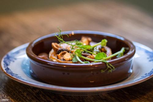 a brown bowl of food on a plate on a table at Liseleje Badehotel in Liseleje