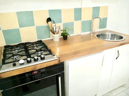 a kitchen with a stove and a sink at Gêna house in Douala
