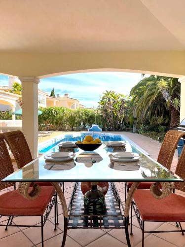 a table with a bowl of fruit sitting on a patio at Magellan House in Vilamoura