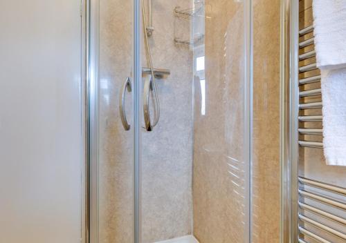 una doccia con porta in vetro in bagno di Dee Mount a Carrog