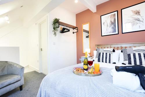 a bedroom with a bed with a tray of food on it at Central Buckingham Apartment #7 with Free Parking, Pool Table, Fast Wifi and Smart TV with Netflix by Yoko Property in Buckingham