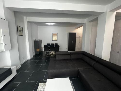 a living room with a couch in the middle at Cozy Aparthotel - Central City Suceava in Suceava