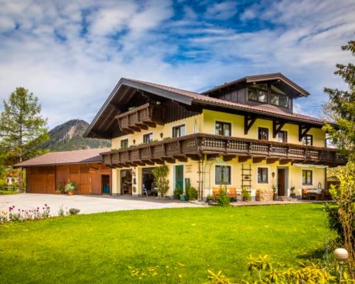 a large house with a green lawn in front of it at Unterwöhrlehen in Faistenau