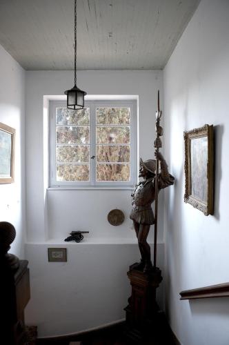 a statue of a man standing in a room with a window at The Villa Averoff in Kírinthos