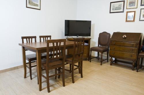 a dining room with a table and chairs and a television at San Marco - Rialto with WIFI in Venice
