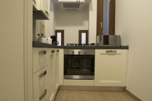 a kitchen with white cabinets and an oven at San Marco - Rialto with WIFI in Venice
