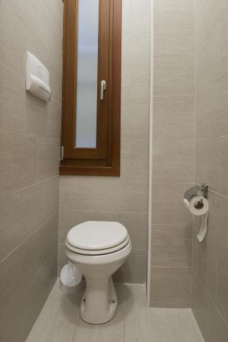 a bathroom with a toilet and a mirror at San Marco - Rialto with WIFI in Venice