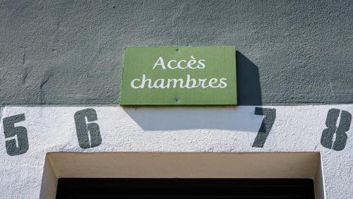 a sign on the side of a building that says access challenges at Hôtel Vauban in Le Palais