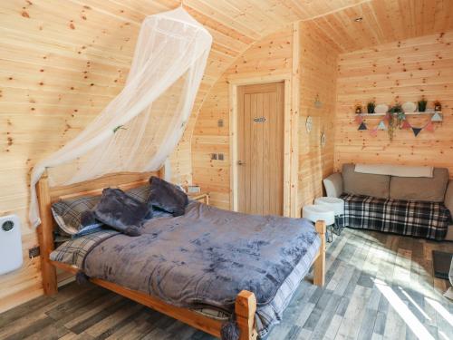 a bedroom with a bed in a wooden cabin at Holiday Cabin 