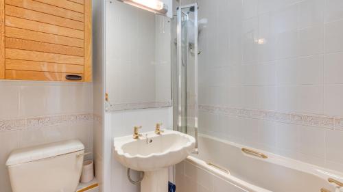 a white bathroom with a sink and a toilet at Redcliffe Apartments E in Bishopston