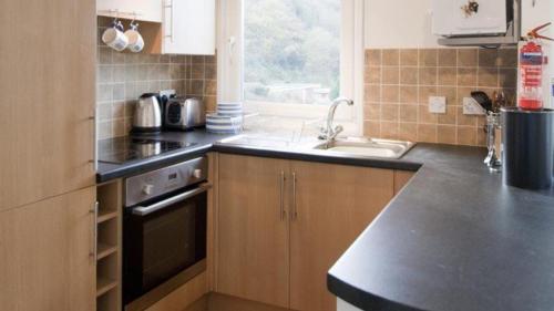 a kitchen with a sink and a stove at Whiteshell 15 in Newton