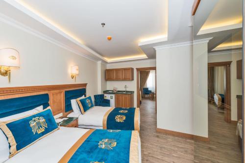 a hotel room with two beds and a kitchen at The Byzantium Suites Hotel & Spa in Istanbul