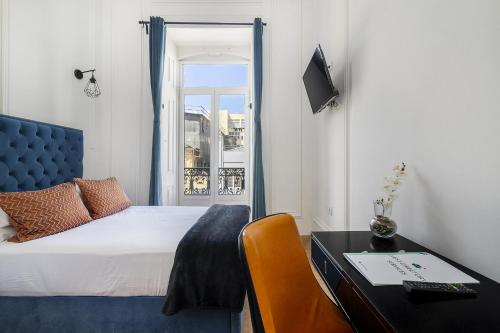 Postel nebo postele na pokoji v ubytování Lisbon 5 Hotel