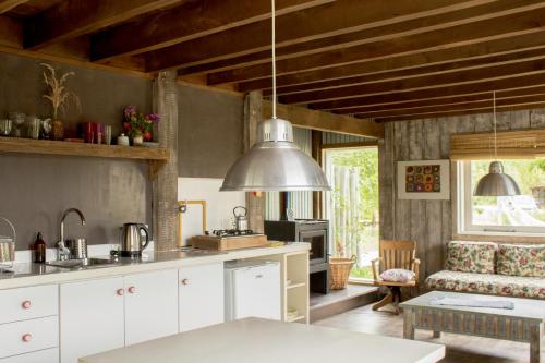 a kitchen and living room with a couch and a table at Chapa Pituca Boutique in San Martín de los Andes