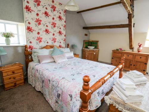 a bedroom with a large bed with a wooden frame at The Cheese Loft in Carmarthen
