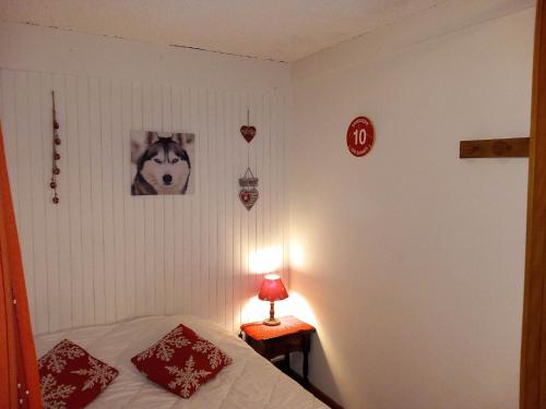 1 dormitorio con 1 cama y 1 mesa con lámpara en Appartement chalet en plein centre des Saisies, en Hauteluce