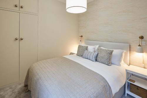 a bedroom with a large white bed with pillows at Host & Stay - Normanby Terrace Apartments in Whitby
