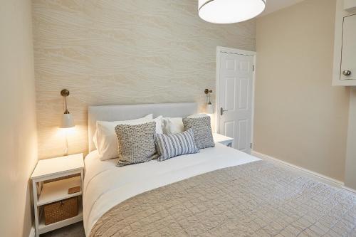 a bedroom with a white bed with pillows on it at Host & Stay - Normanby Terrace Apartments in Whitby