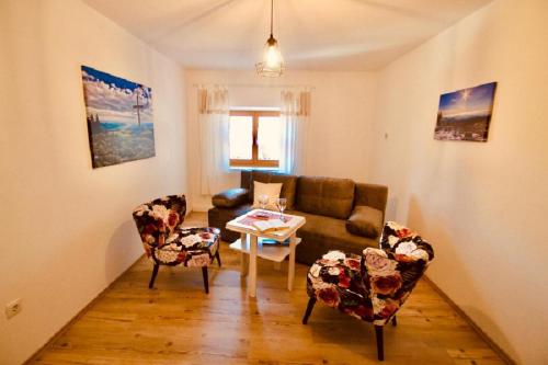 a living room with a couch and chairs and a table at Landurlaub bei Familie Haug in Freyung