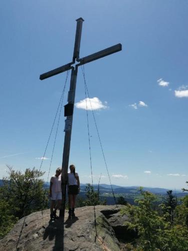 two people standing next to a cross on a rock at Landurlaub bei Familie Haug in Freyung